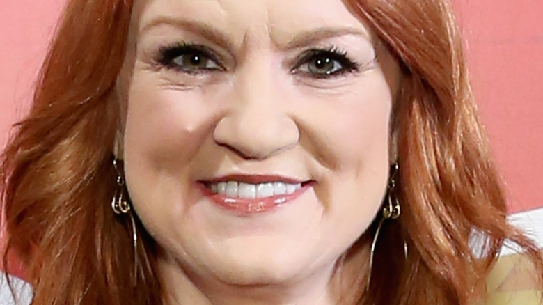 Ree Drummond smiles with red hair and dangling earrings