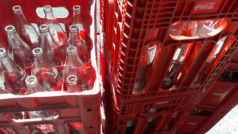 Empty glass bottles in red crates