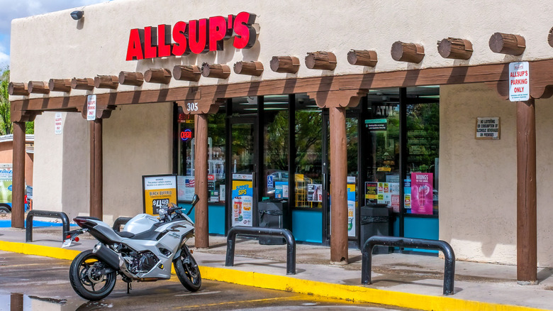 Allsup's gas station exterior with motorcycle in one of the parking spots