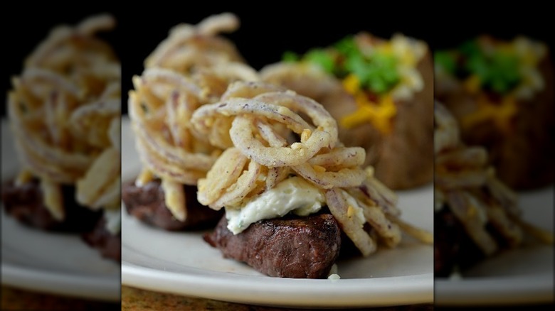 steak topped with fried onions