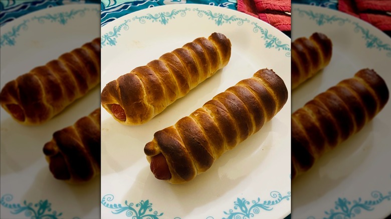 Auntie Anne's pretzel dogs reheated on a white plate with blue flowers on the rim