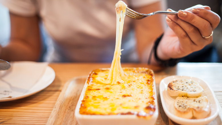 Woman eating a lasagna