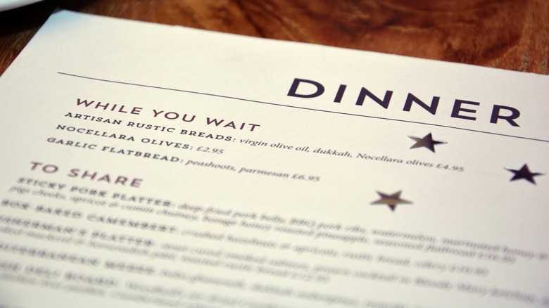 A closeup of a menu on a wood table