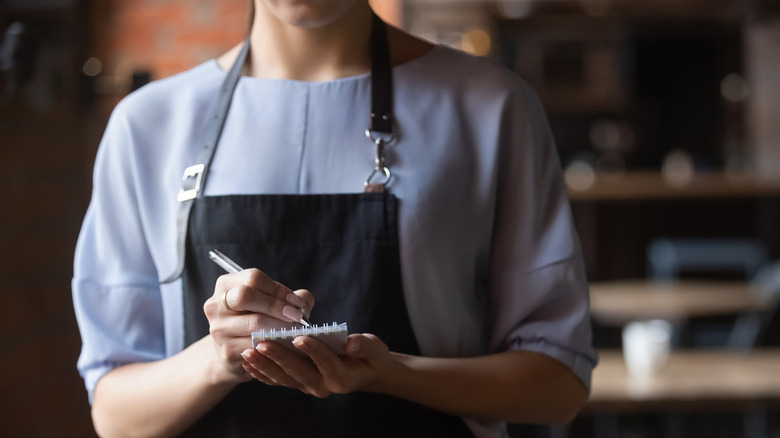 A waitress taking orders