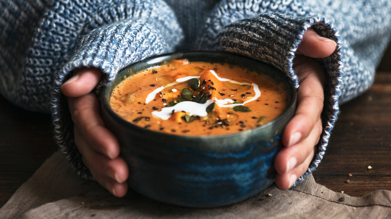 Bowl of soup cradled by hands