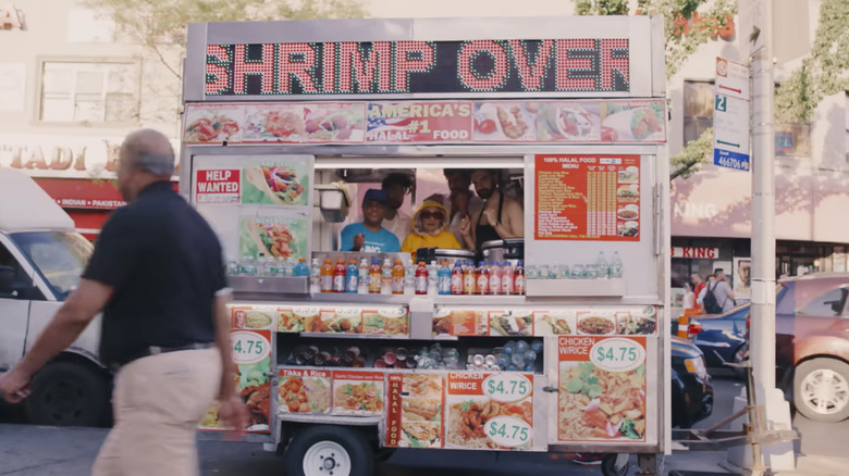 Music video "Nani" with a man walking by a street food cart on a Queens, New York street