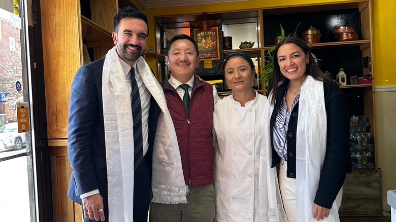 Zohran Mamdani stands with the staff of Laliguras Bistro and Representative Alexandria Ocasio-Cortez