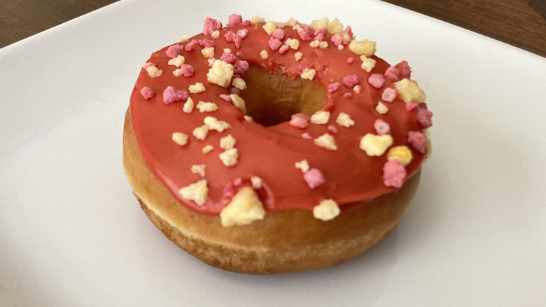 A close-up of a fruit punch donut