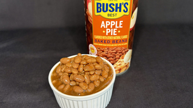 Bush's Apple Pie Flavored baked beans can behind white dish filled with beans