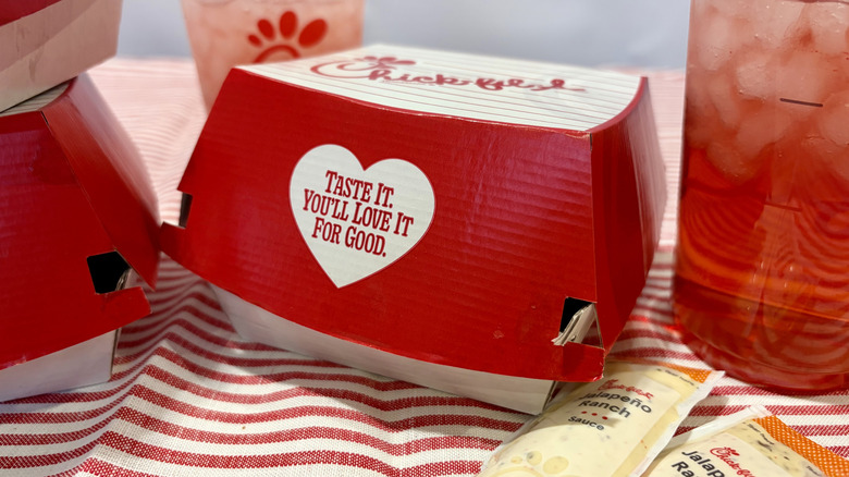 A box of Chick-fil-A's new Jalapeno Ranch Club Chicken Sandwich and Strawberry Hibiscus beverages with Jalapeno Ranch sauce packets.