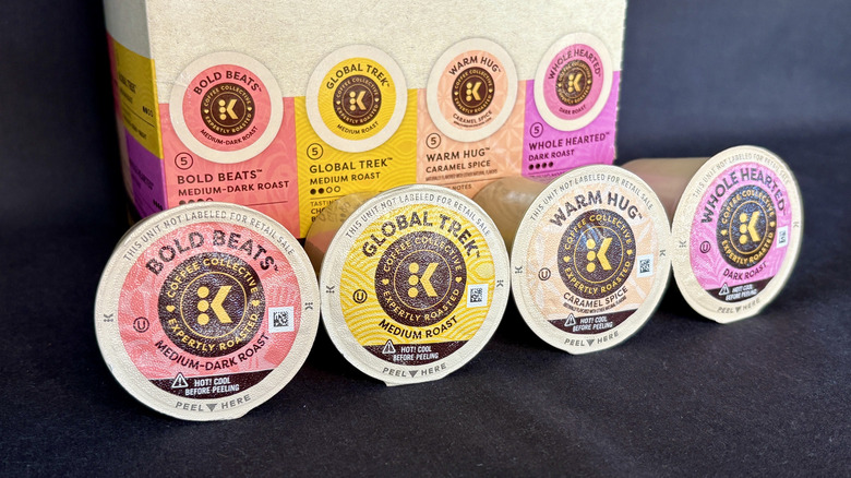 Four Keurig Coffee Collective K-Cups lined up in front of the Keurig box