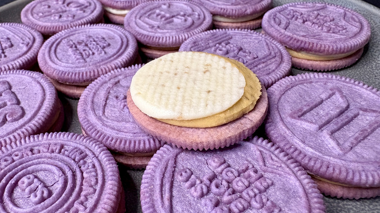 Purple Oreos on plate with open cookie on top