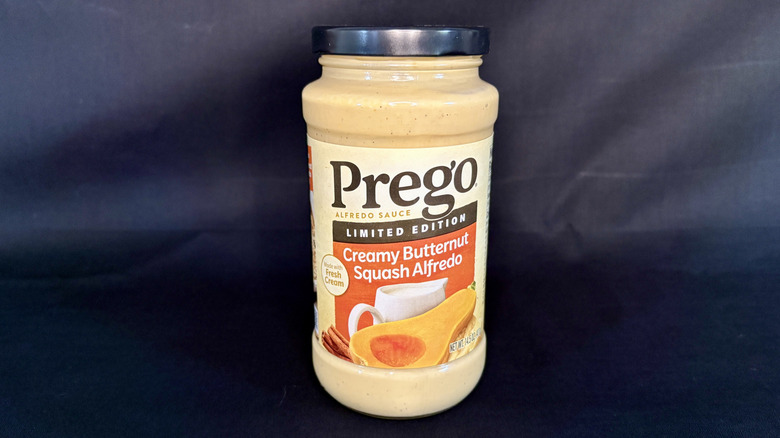 A jar of Prego Creamy Butternut Squash Alfredo Sauce on a black background