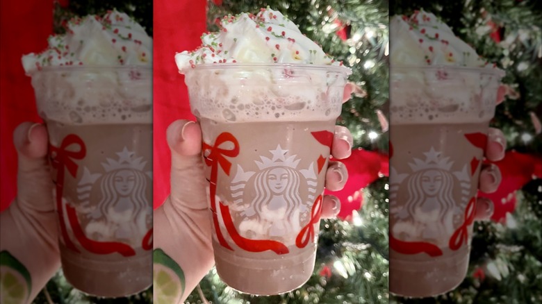 A hand holding the new Frozen Peppermint Hot Chocolate from Starbucks cafes located in Target stores