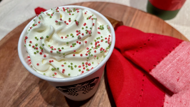 The whipped cream and sprinkles on top of a Frozen Peppermint Hot Chocolate