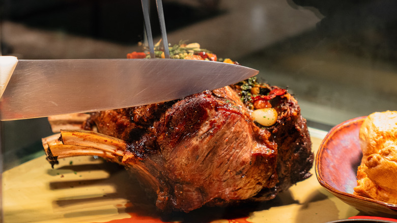 Prime rib being sliced at a carving station
