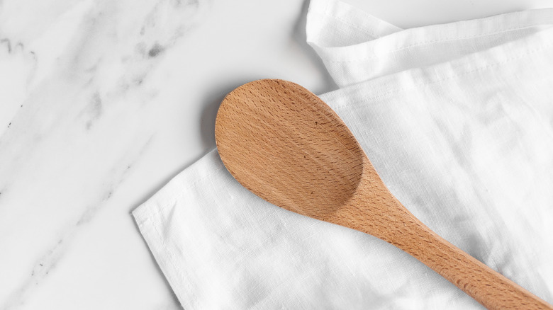 Wooden spoon on white linen marble counter