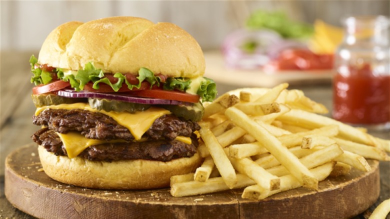 Burger and fries on brown wood