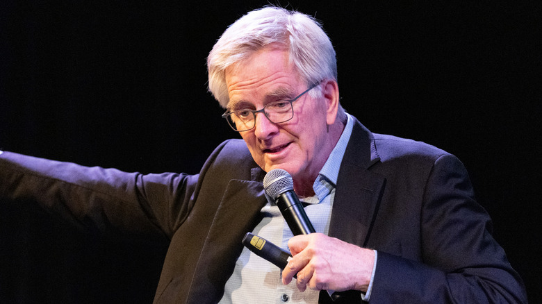 Rick Steves holding microphone