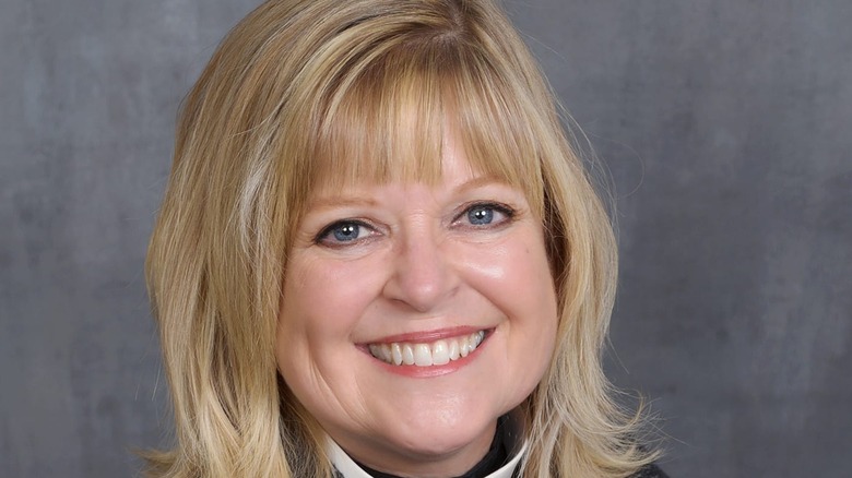 Shelley Bryan Wee smiling against gray background