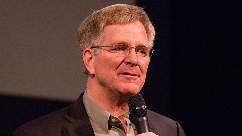 Rick Steves holding microphone