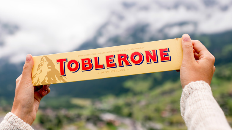 two hands holding Toblerone