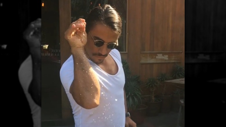Nusret Gökçe, also known as Salt Bae, sprinkles salt flakes in the Instagram video that went viral in 2017