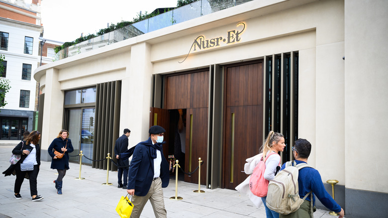 People walking past the Nusr-Et restaurant in London