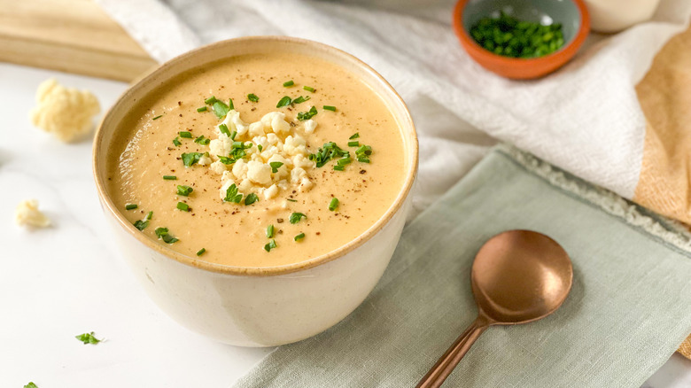 Cauliflower soup on a table with spoon