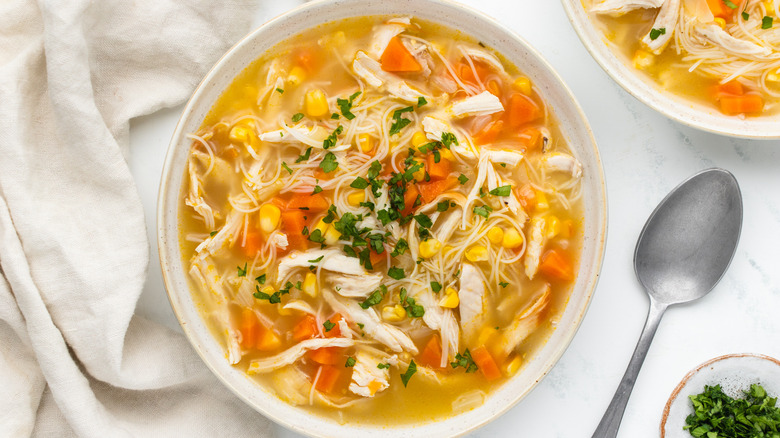 Corn and chicken noodle soup in bowl
