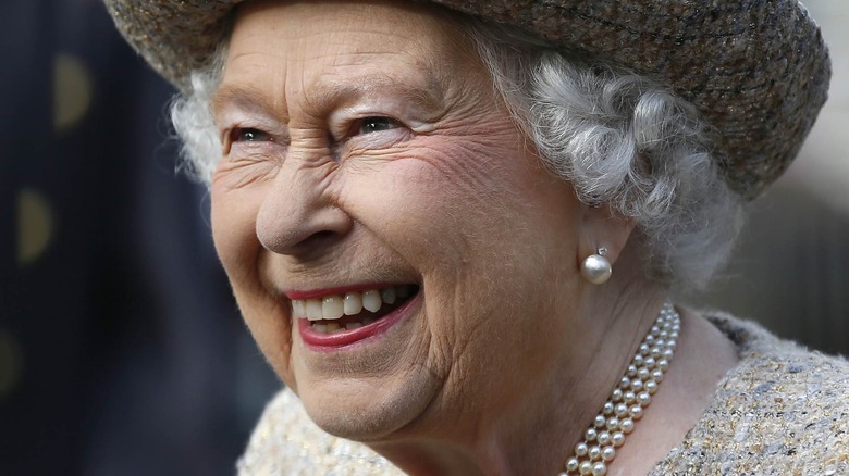 Queen Elizabeth II with wide smile and wool hat