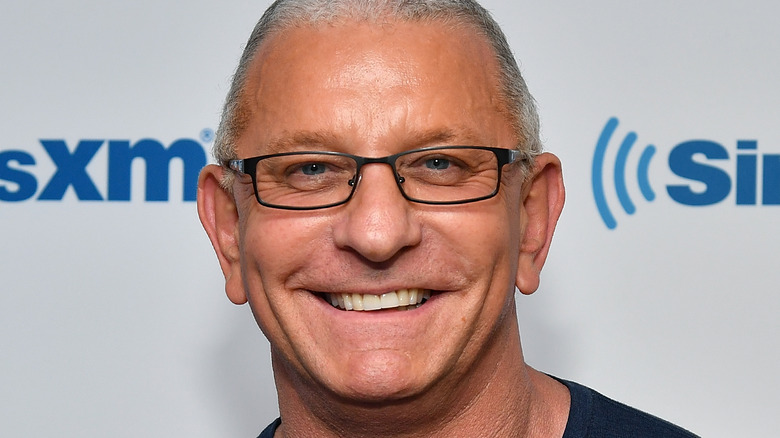 Robert Irvine smiles with glasses