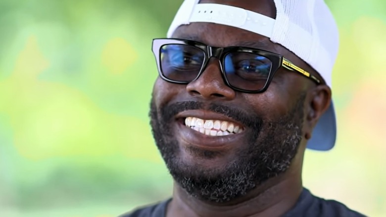 Rodney Scott smiles at the camera in sunglasses