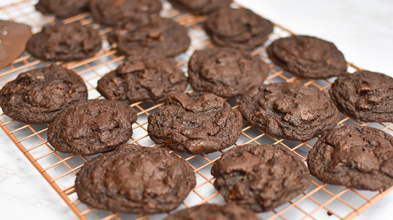 Double chocolate chip cookies on a wire rack