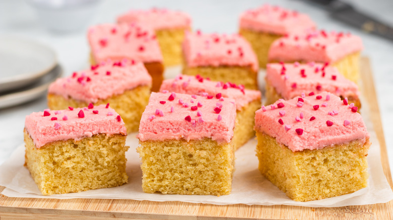 pink icing cake on tray 