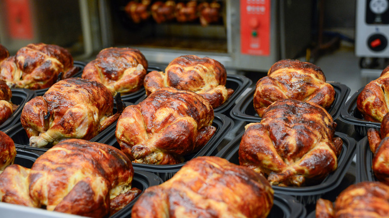 Cooked rotisserie chickens in trays