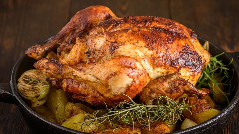 Whole roasted chicken in skillet
