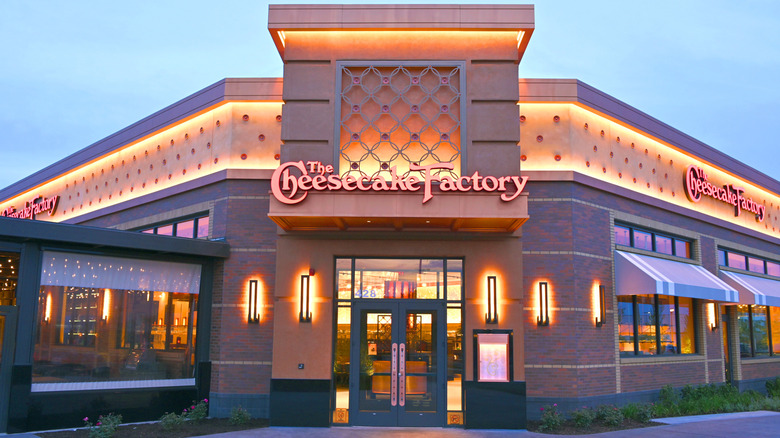 Exterior facade of The Cheesecake Factory at dusk