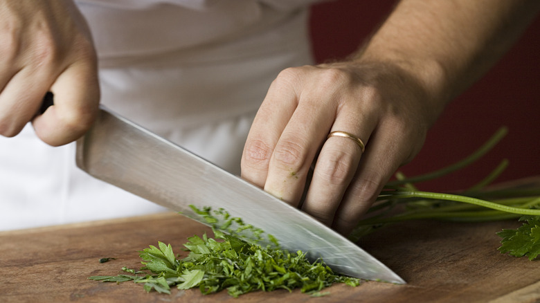 Chef chopping herbs