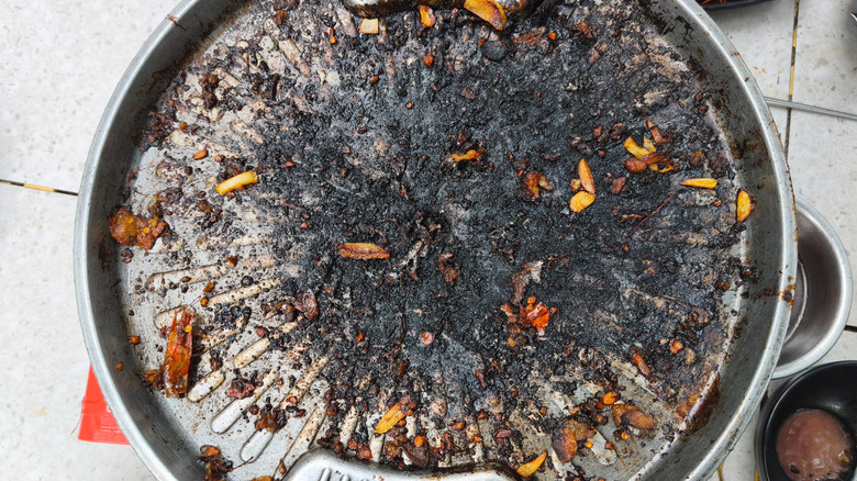 Heavily charred grill with slivers of garlic and meat