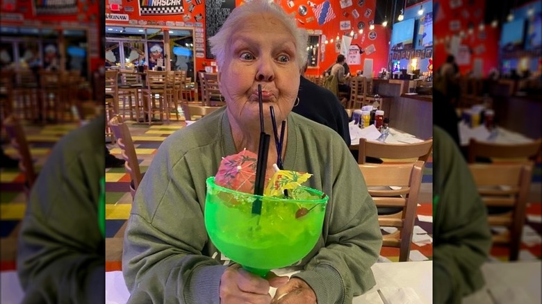 An older woman drinking Dick's Last Resort's Big Dick Margarita