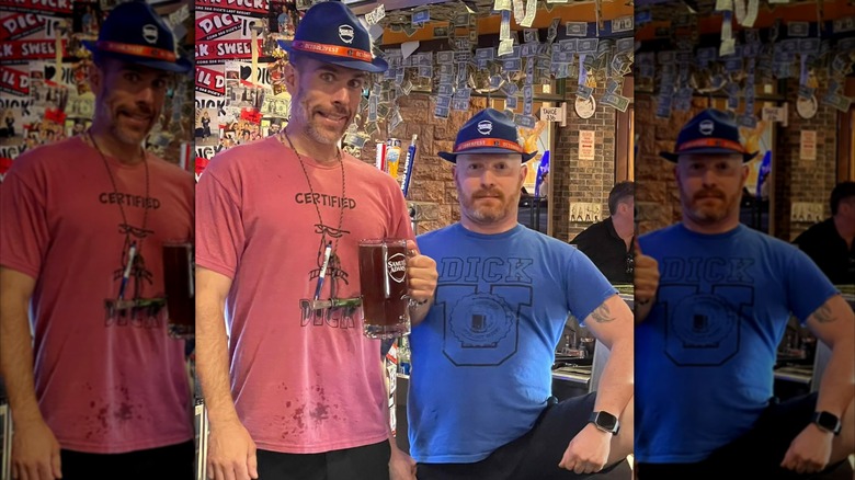 Two men wearing Dick's Last Resort merch while holding a glass of beer