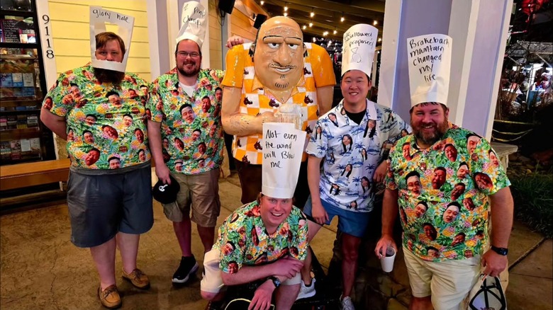 A group of men posing with a Dick statue at Dick's Last Resort