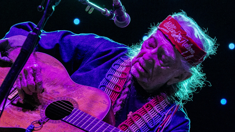 Willie Nelson performing on stage