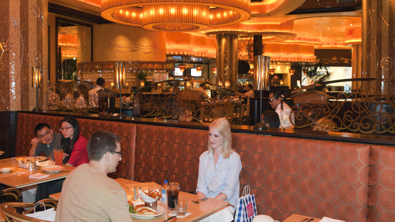 Customers seated inside the Cheesecake Factory.