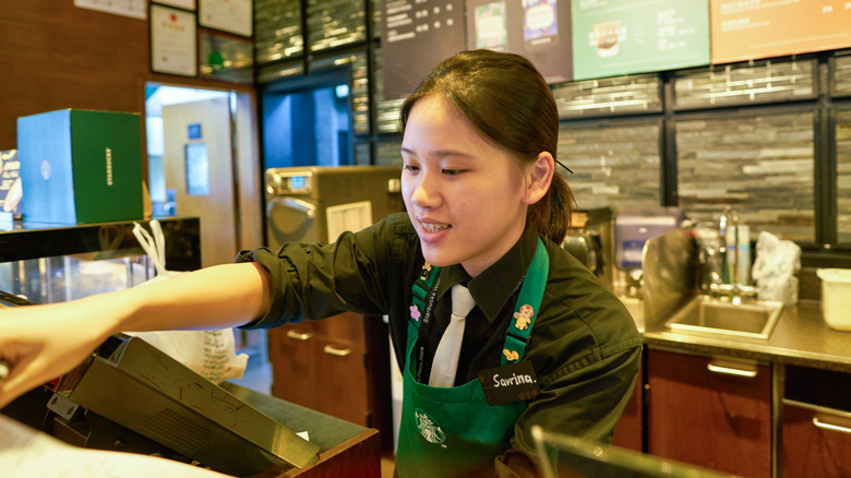 Starbucks barista working the cash register