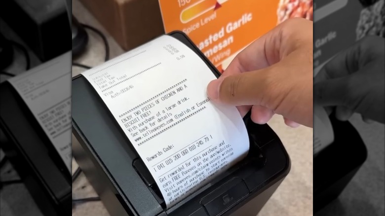 A Popeyes receipt coming out of the printer