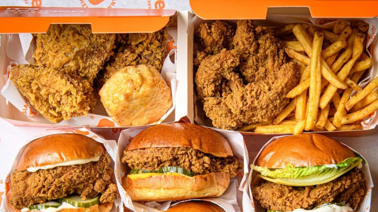 Two Popeyes combo boxes and three chicken sandwiches