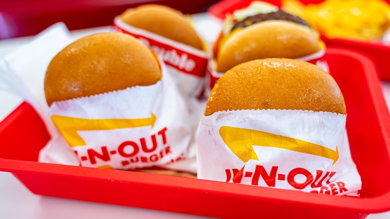 four In-N-Out burgers in a red tray