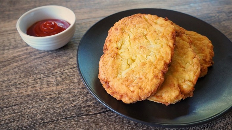 Hash browns on black plate